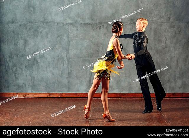 Young couple dancers dancing ballroom dance cha-cha-cha