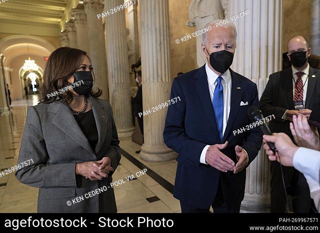 United States President Joe Biden speaks to the media as he departs with US Vice President Kamala Harris through the Hall of Columns after he spoke in Statuary...