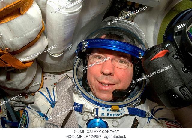 NASA astronaut Michael Barratt, Expedition 20 flight engineer, attired in a Russian Sokol launch and entry suit, occupies his seat in the Soyuz TMA-14 during...