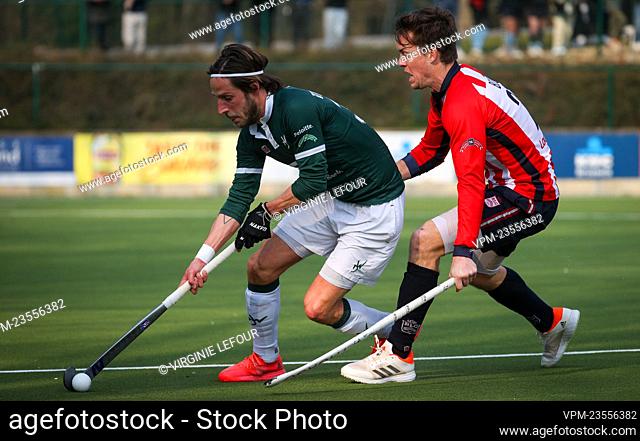 Watduck's Elliot Van Strydonck and Leopold's Tom Boon fight for the ball during a hockey game between Royal Leopold Club and Waterloo Ducks