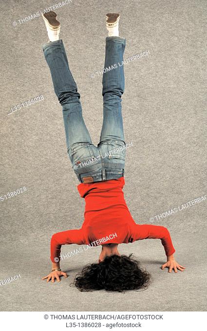 Young woman doing a headstand