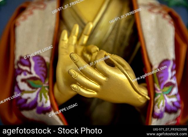 Detail of a statue in a buddhist temple in western France