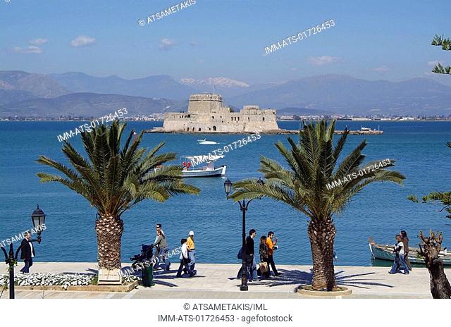 View of Bourtzi fortress from the town, people, palm trees , Nafplio, Argolis, Peloponnese, Greece