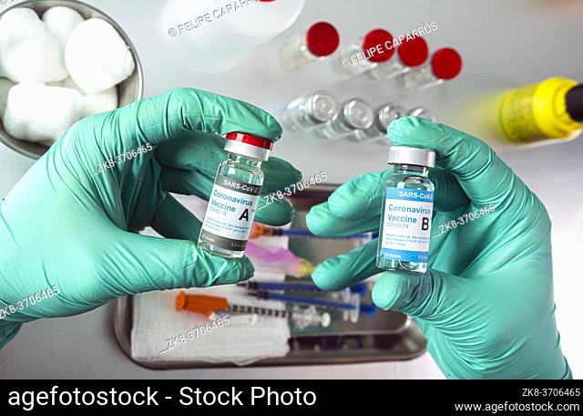 Nurse holds two covid-19 vaccines from different laboratories, conceptual image