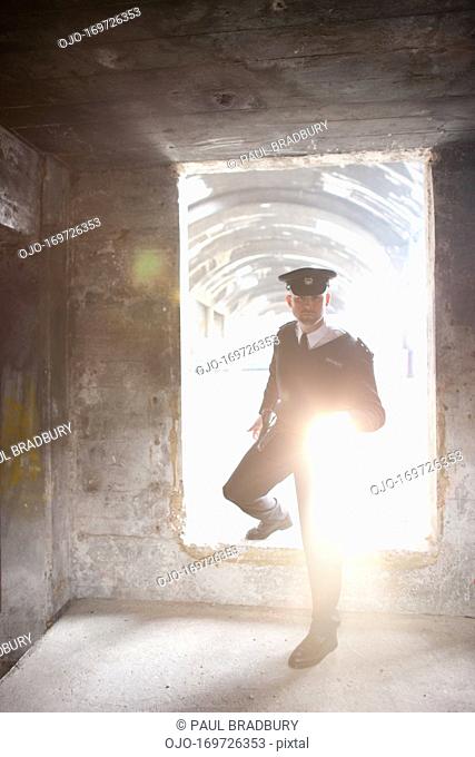 Security guard with flashlight checking bunker