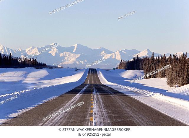 Alaska Highway in winter, St. Elias Mountains behind, Kluane National Park and Reserve, Yukon Territory, Canada