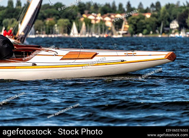 stern of a classic sailing yacht sailing on a lake during a regatta