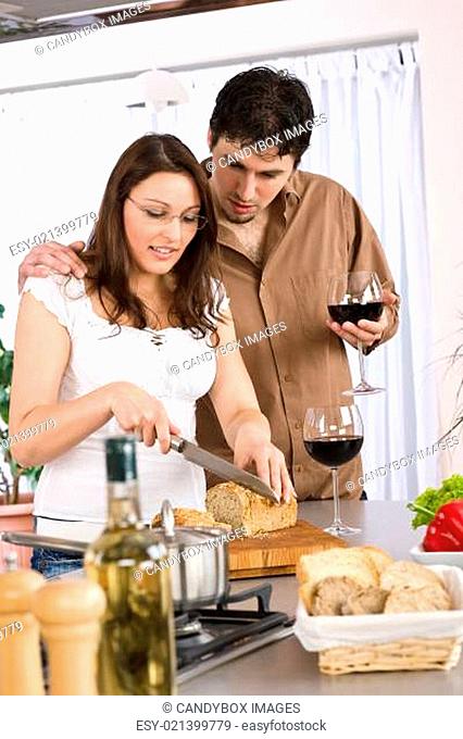 Cooking - happy couple together in modern kitchen