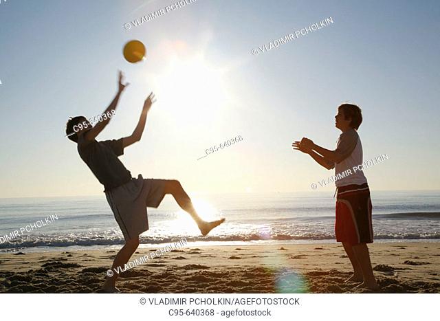Virginia Beach, Virginia, USA, 2 boys playing on the beach, 13 years old