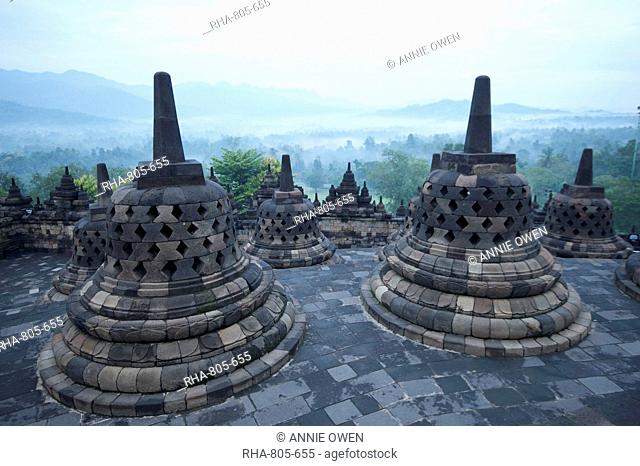 View over early morning monsoon mist lying across countryside, Borobudur Buddhist Temple, UNESCO World Heritage Site, Java, Indonesia, Southeast Asia, Asia