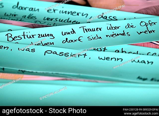 27 January 2023, Brandenburg, Oranienburg: Colored adhesive tapes with, among other things, the words ""dismay and mourning for the victims"" lie on a table in...