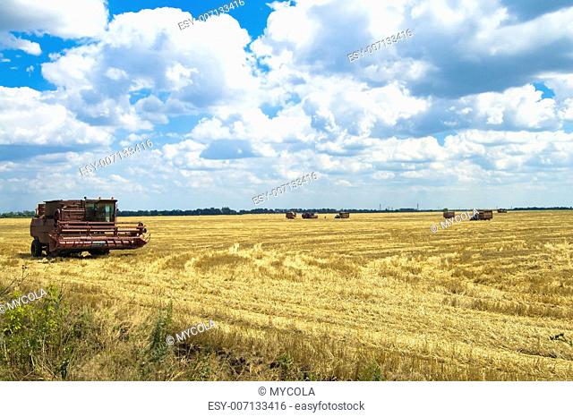 combine harvester working a wheat field