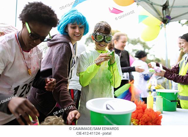 Runners with wig and holi powder at charity run tent