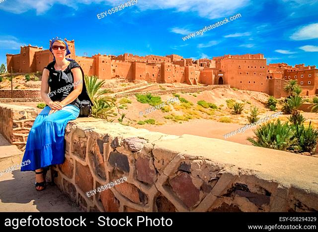 Pregnant woman tourist in front of Kasbah in Ouarzazate, Morocco