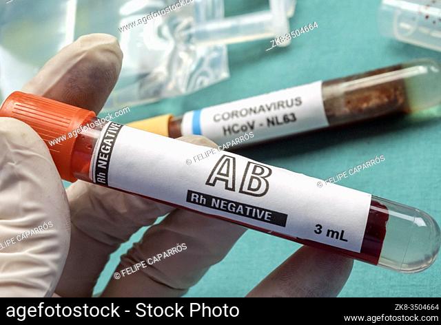 Nurse holds plasma Rh negative vial to transfuse patient covid19, conceptual image