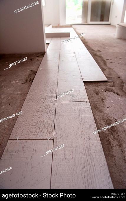 Ceramic wood effect tiles and tools for tiler on the floor unfinished laying floor tiles Floor tiles installation