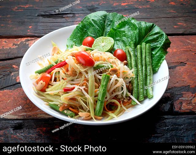 Top view Thai food rice noodle papaya salad isolated on rustic wooden table