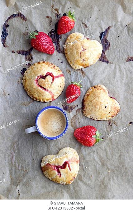 Hand pies (mini pies) with a strawberry filling and heart decorations