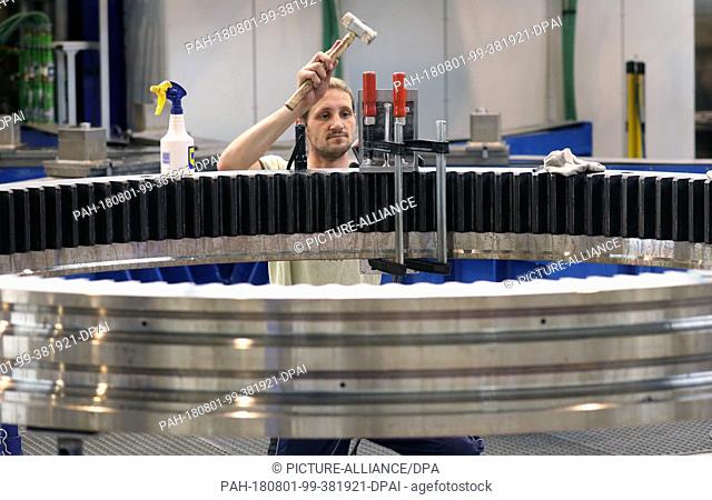 01 August 2018, Germany, Rostock: Mathias Kossack is working on a part for a large-diameter antifriction bearing in the lubrication systems of the German...