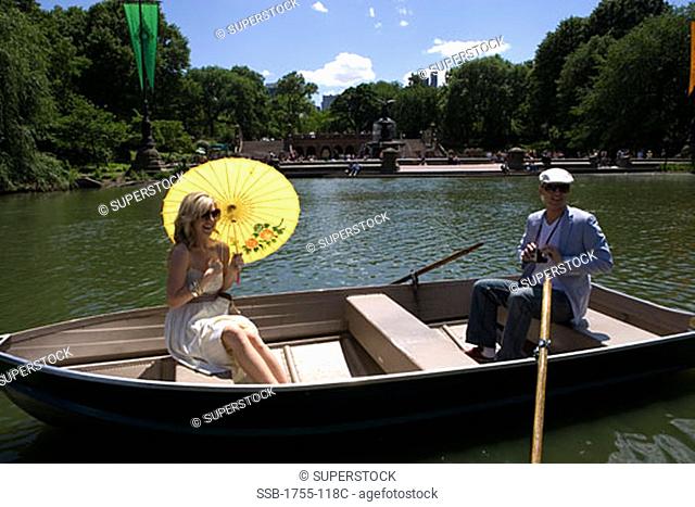 Young couple sitting in a boat, Central Park, Manhattan, New York City, New York, USA