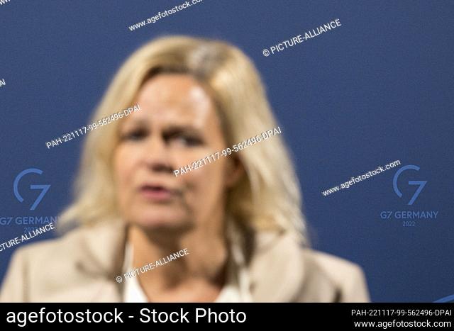 17 November 2022, Hessen, Eltville am Rhein: Nancy Faeser, Federal Minister of the Interior and Home Affairs out of focus in front of a press wall with G7 logo...