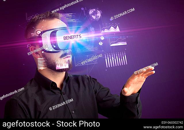 Businessman looking through Virtual Reality glasses with BENEFITS inscription, new business concept