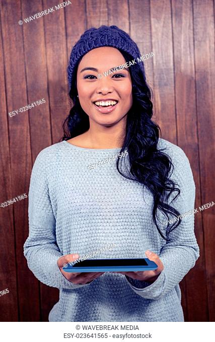Asian woman holding tablet