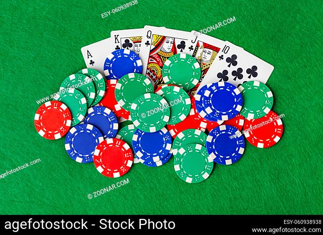 Casino chips and playing cards on green table - gambling background