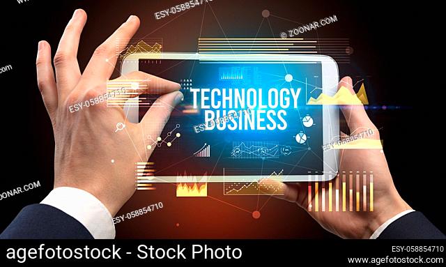 Close-up of hands holding tablet with BUSINESS EDUCATION inscription, modern business concept