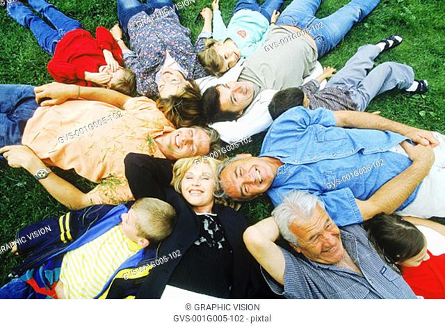 High angle view of a family lying on grass