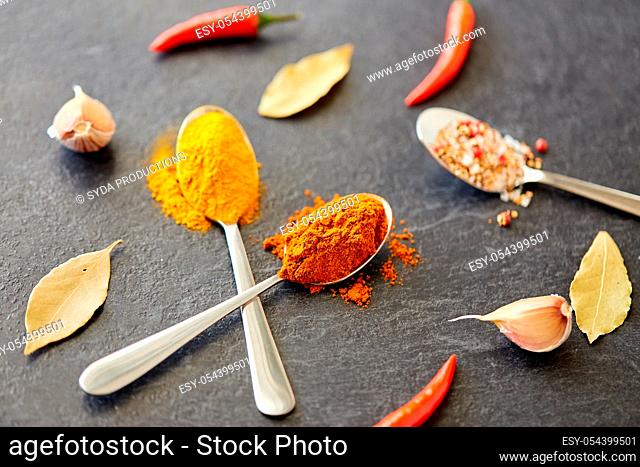 spices, chili pepper, bay leaf and garlic on stone