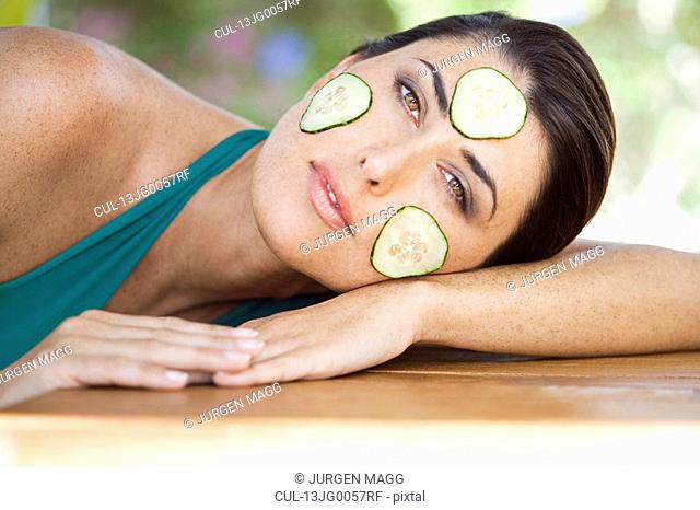 A female with cucumber on her face