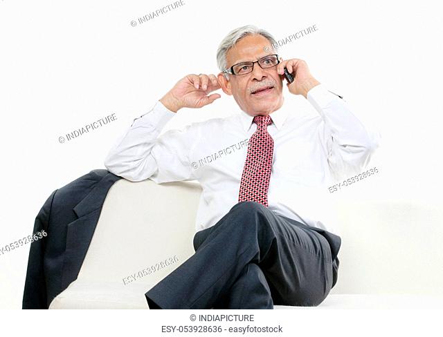 Old businessman taking on the phone
