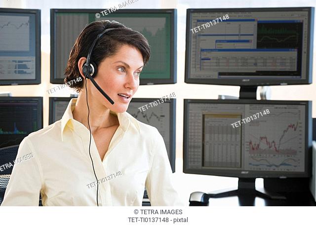 Female trader on headset