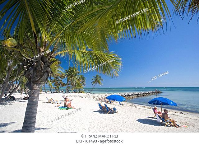 People at a palm beach under blue sky, Smathers Beach, Key West, Florida Keys, Florida, USA