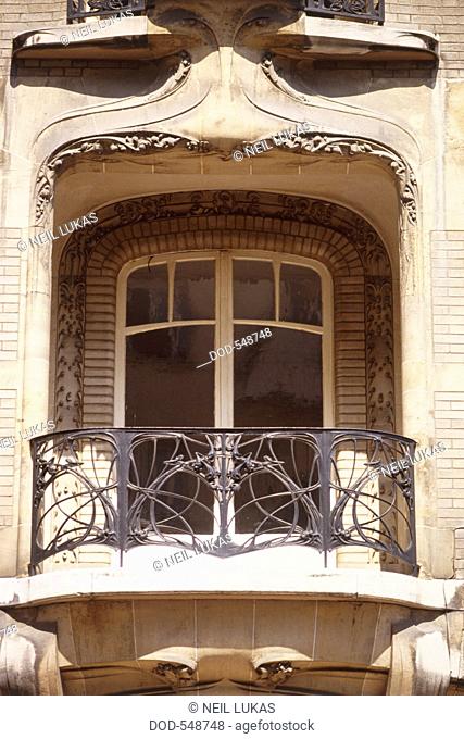 France, Paris, Rue de la Fontaine, french balcony with double doors and wrought iron railing, art nouveau window with balcony
