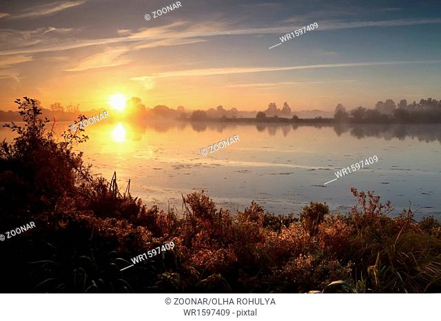 rising sun over wild lake