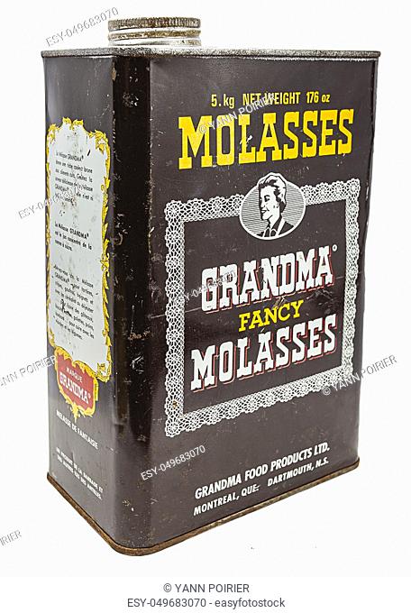 metal box of molasses against a white background
