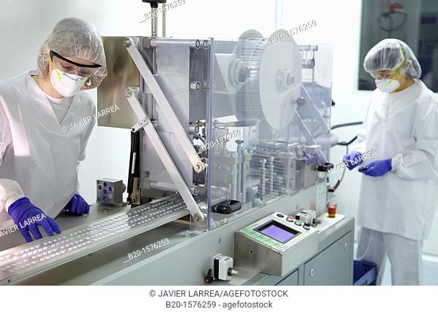 Technicians performing in-process control of tablets in a blister packaging, Clean room, Pharmaceutical plant, Drug manufacturing plant, Research Center