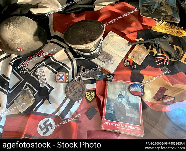 28 August 2021, Russia, St. Petersburg: Exhibits lie in a glass vault at the Museum of Leningrad's Defence, including a swastika flag
