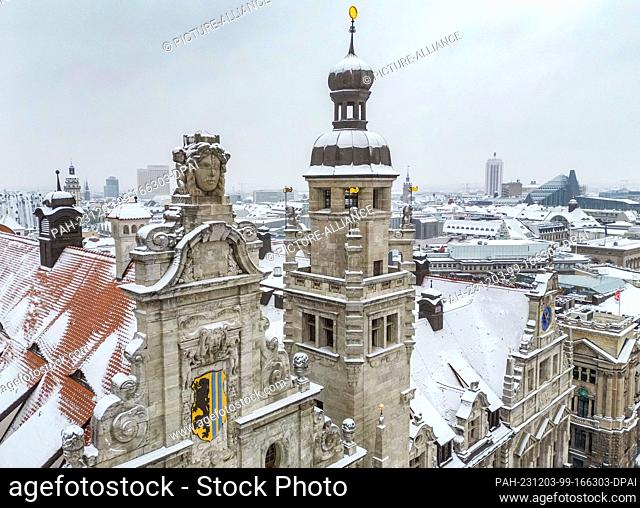03 December 2023, Saxony, Leipzig: Snow lies on the turrets and roofs of the New Town Hall. However, the winter magic is not expected to last much longer