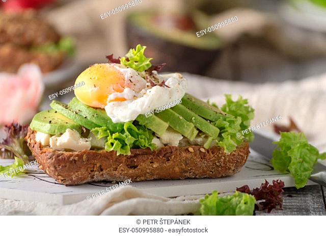 Homemade avocado poached egg sandwich wholegrain bread, food photography