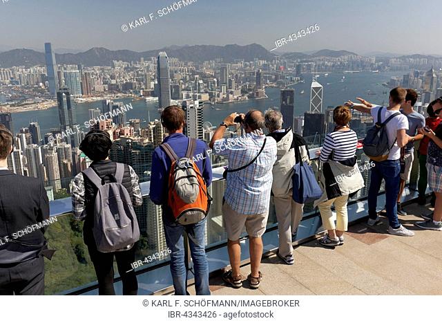 Tourists on the observation deck of The Peak, Victoria Peak, View of Victoria Harbour and Kowloon, Hong Kong Island, Hong Kong, China