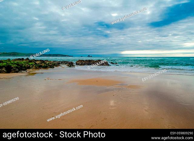 View of Valdearenas beach in Cantabria, Spain, at sunset