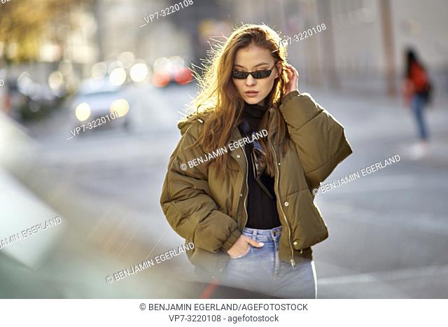 fashionable blogger woman walking in city streets with cool individual style, in Munich, Germany