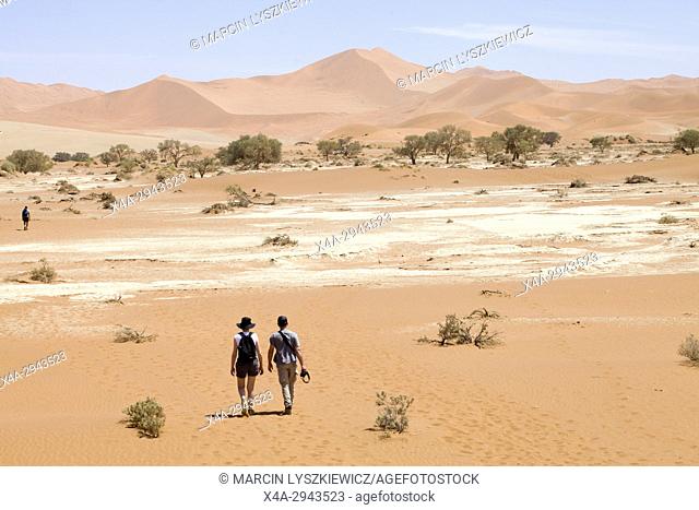 A young couple walking on the desert