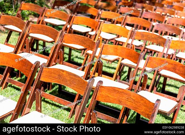 Rows of Wooden Event Chairs at Wedding Venue Abstract