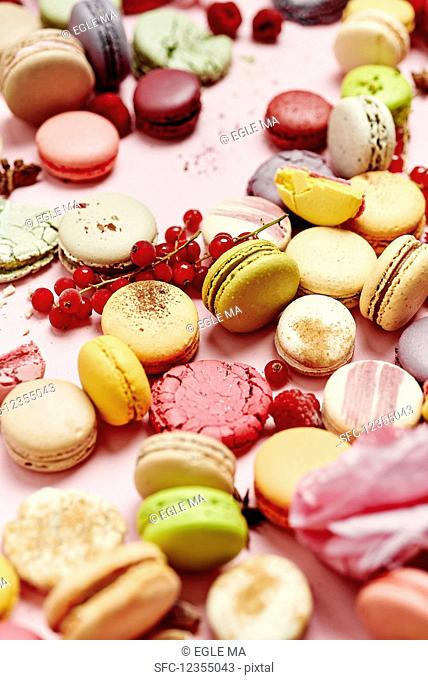 Still life of different varieties of French macarons on a pink background