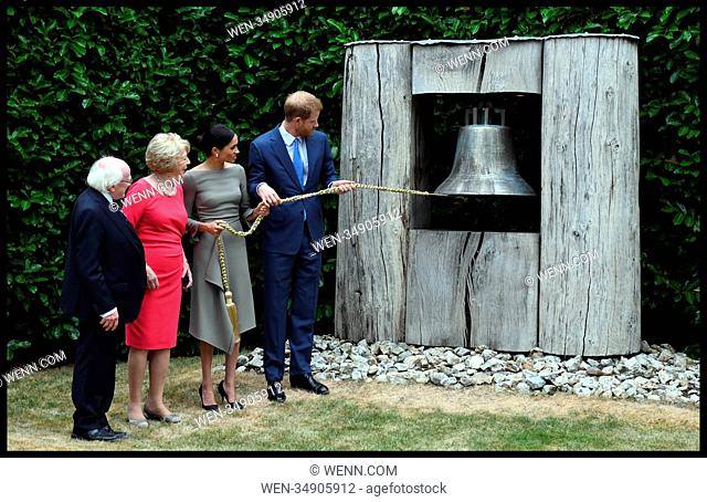 The Duke and Duchess of Sussex in Ireland-Day Two. Prince Harry, The Duke of Sussex, accompanied by his wife The Duchess of Sussex ring the peace Bell while...