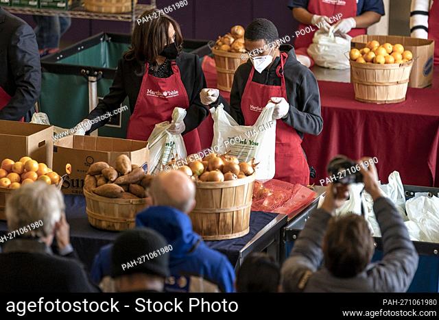 United States Vice President Kamala Harris helps bag produce with volunteer Brian Williams, 15, as she participates in a community service event at Martha’s...